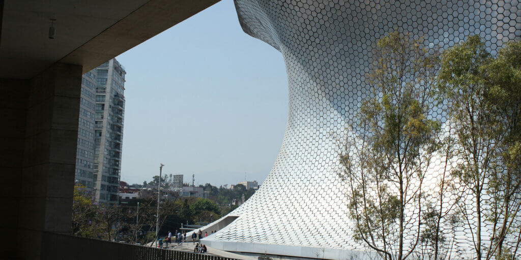The Soumaya Museum Building in Polanco Mexico City with an extensive metal framework on its roof, exemplifying a blend of functionality and modern architecture.